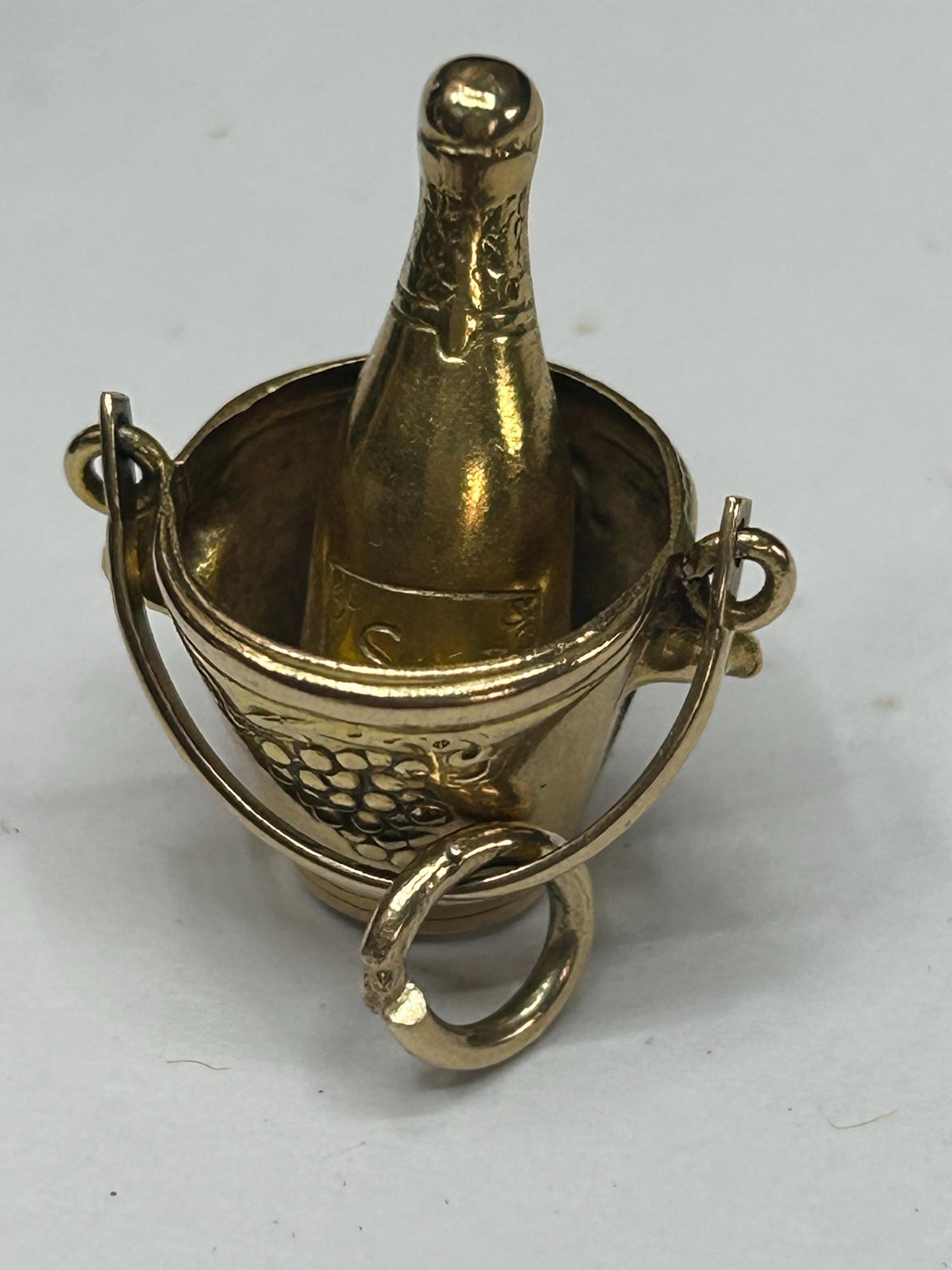 gold champagne bottle in bucket nicely engraved with grapes both sides