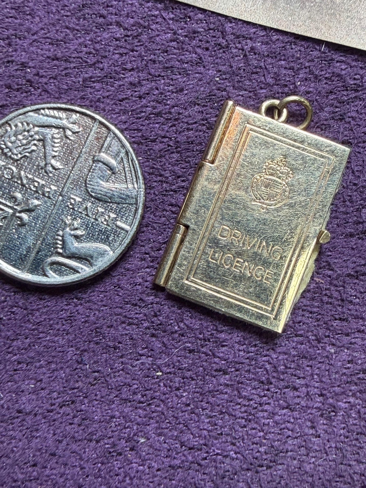 9 ct driving licence charm in really good condition for age - fully opens with papers inside .
