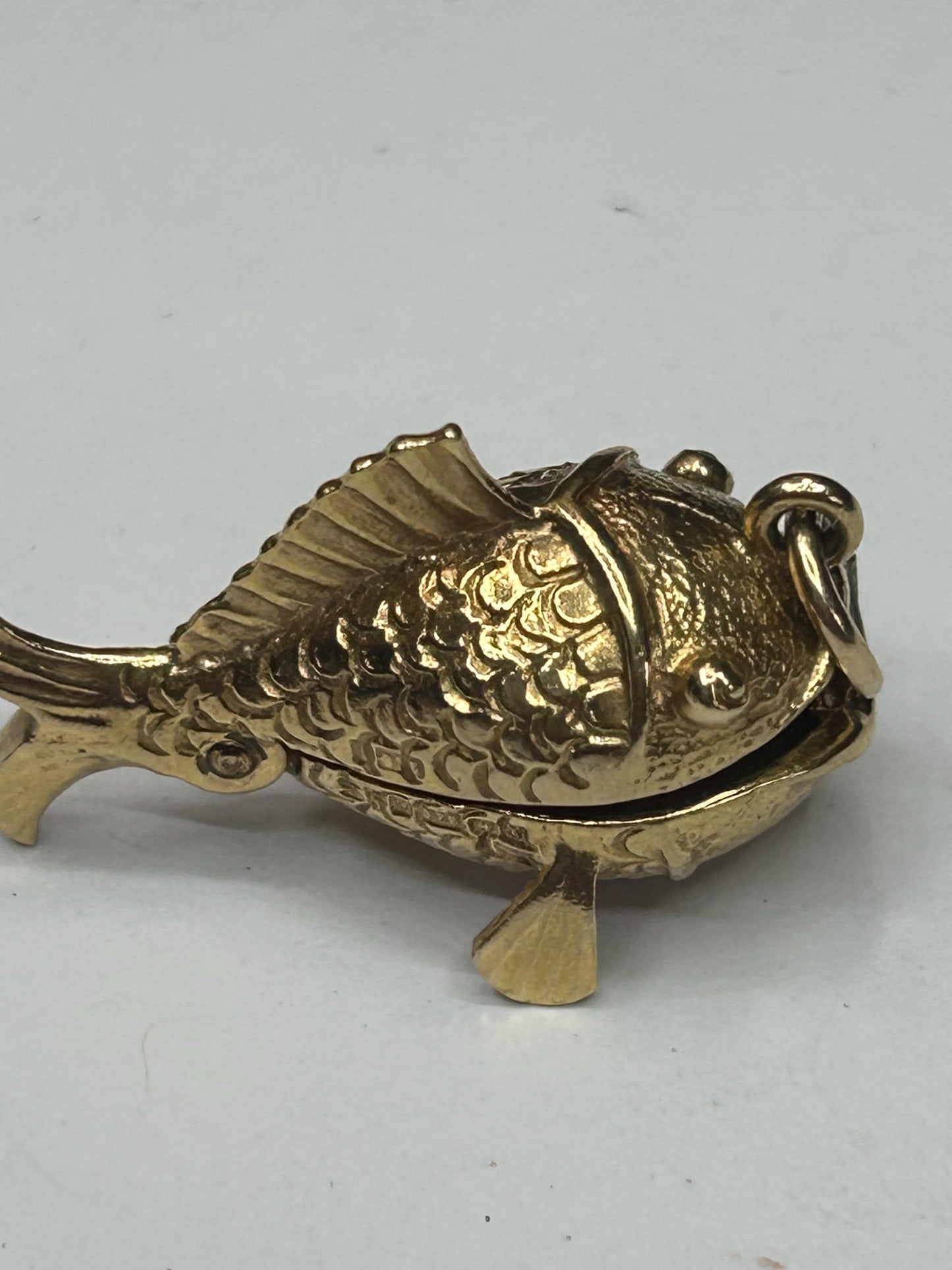 9 ct ornate fish charm with a little man in a boat inside - unique piece