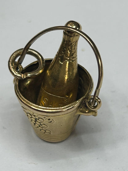 gold champagne bottle in bucket nicely engraved with grapes both sides