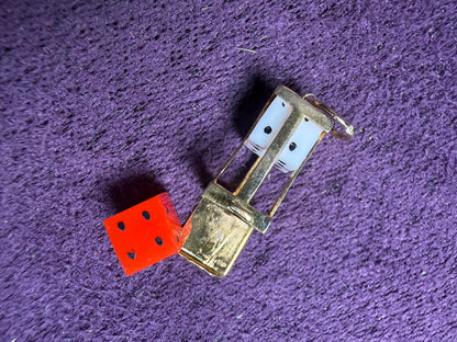 Dice Holder - dated 1989 . Nice outer case in 9 ct gold hold two dice one white one red - the case hinges open at the bar so 