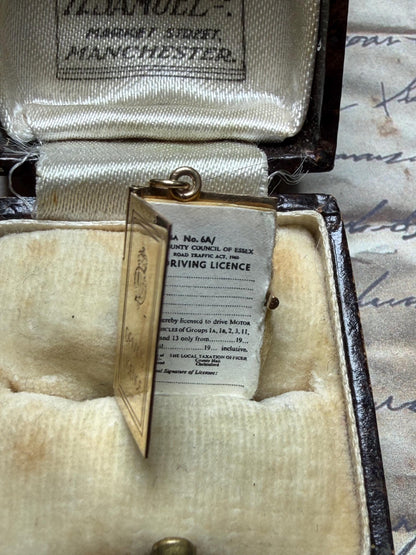 9 ct driving licence charm in really good condition for age - fully opens with papers inside .