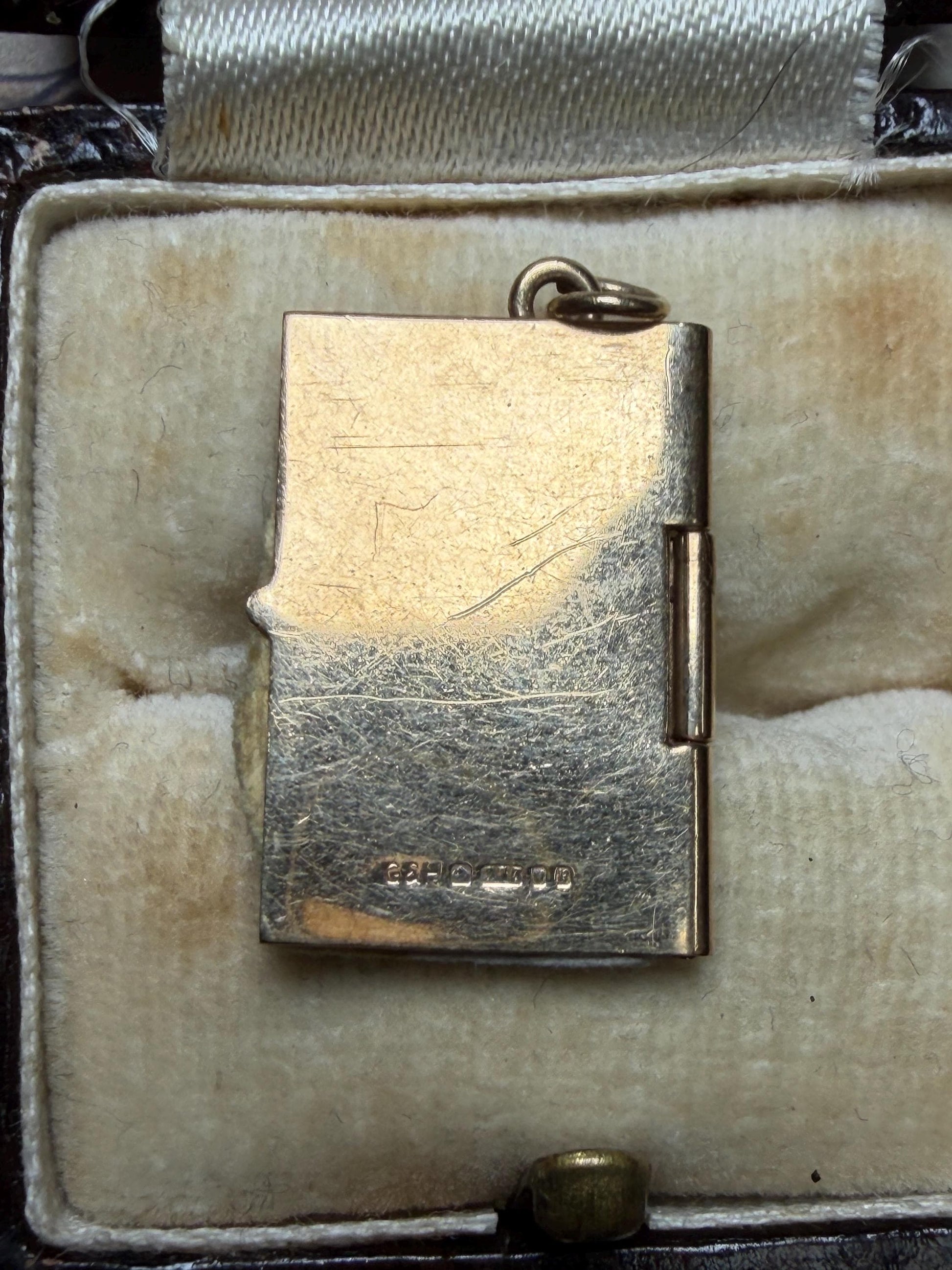 9 ct driving licence charm in really good condition for age - fully opens with papers inside .