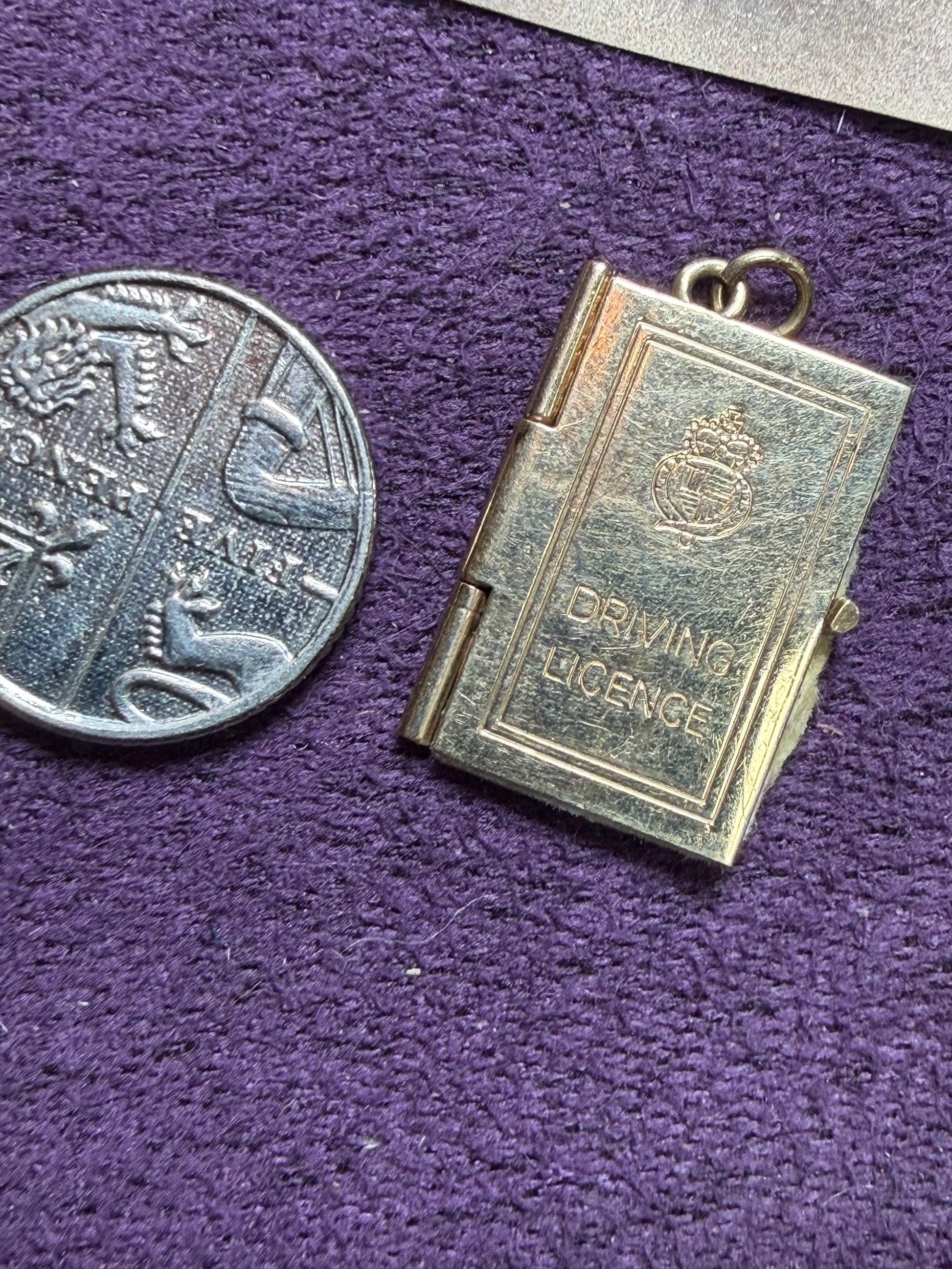 9 ct driving licence charm in really good condition for age - fully opens with papers inside .