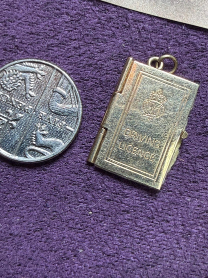 9 ct driving licence charm in really good condition for age - fully opens with papers inside .