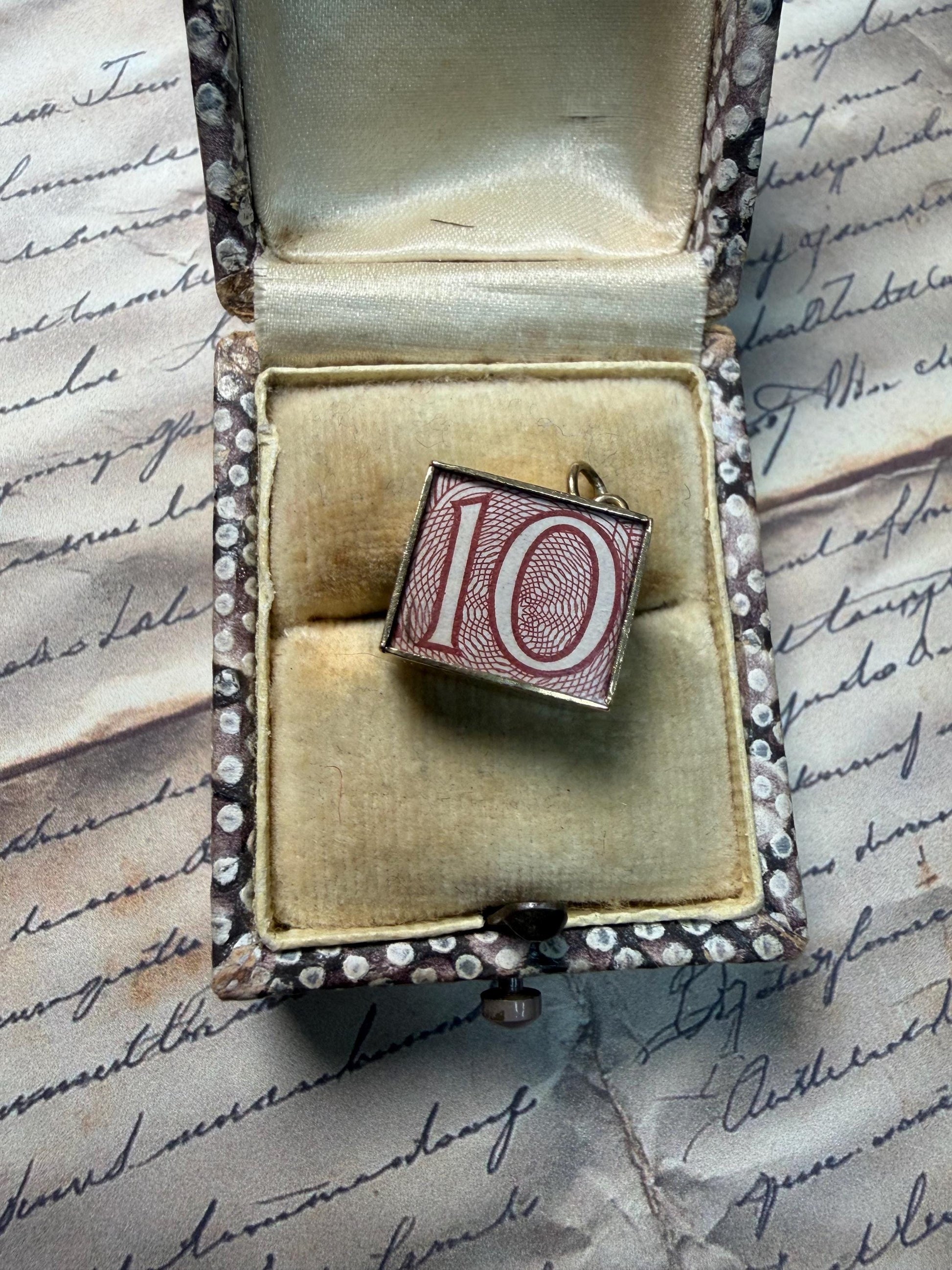 An old 10 pound note in a cute gold box